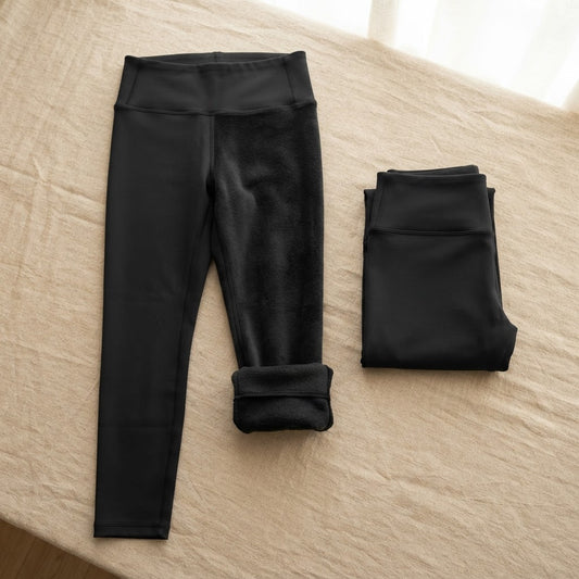 Black thermal fleece-lined womens leggings laid flat showing soft brushed interior